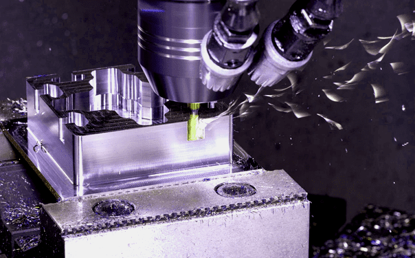 A machine is cutting metal with a green tool.